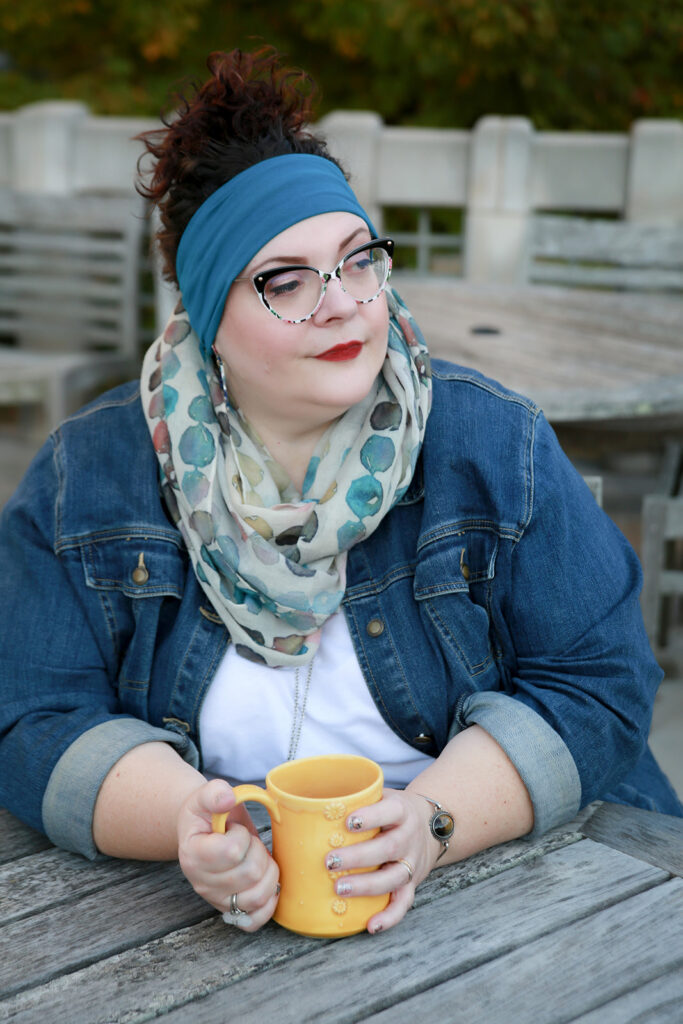 blog author sitting with a a coffee mug with a contemplative gaze.